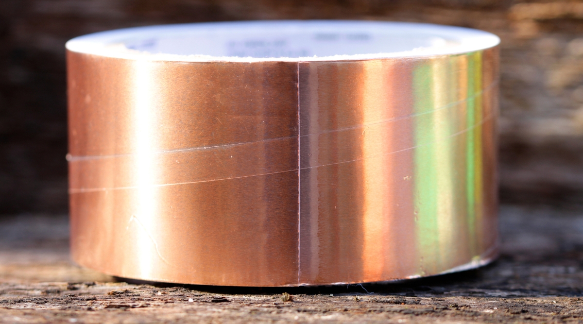 A close up image of a copper barrier used for deterring insects roaming the garden.