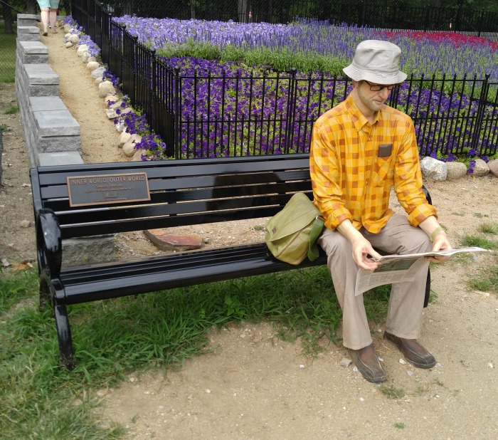 Stature of a man with a newspaper