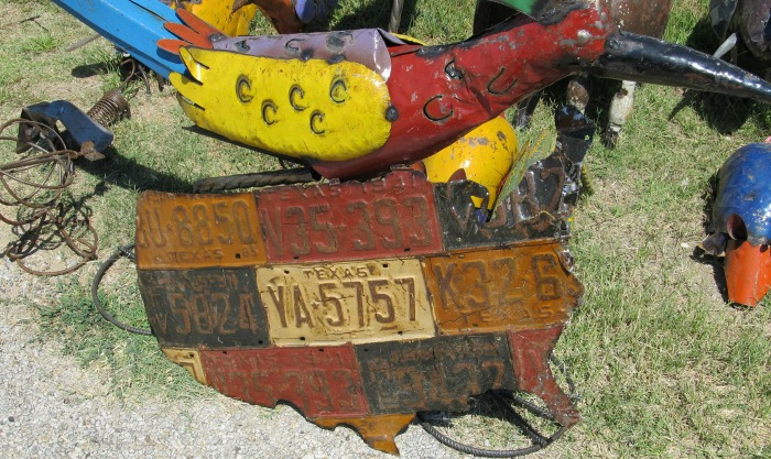 Metal yard art with license plates